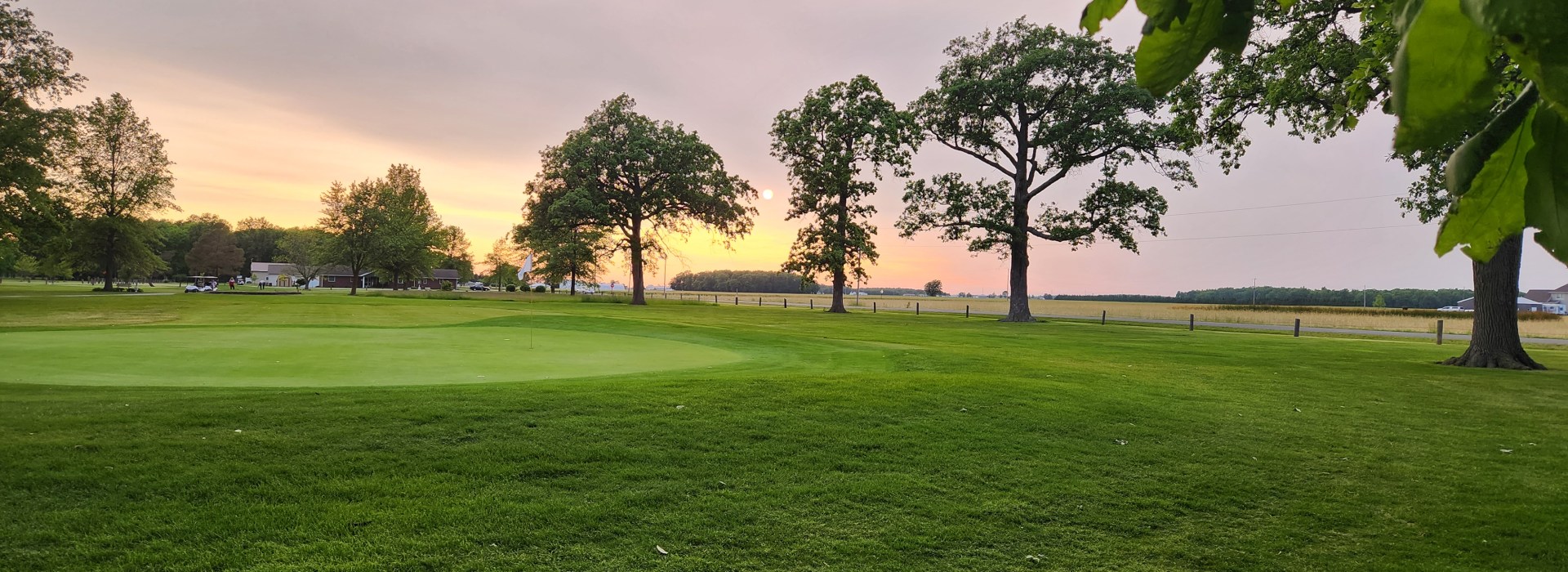 Image of golf ball on tee on grass.